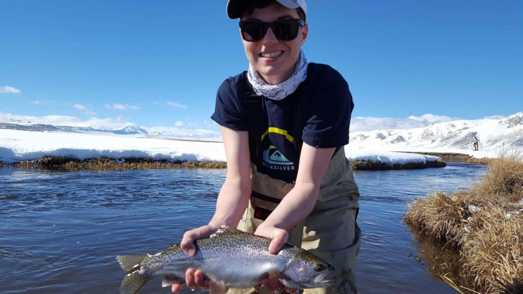 Young man holds big Trout while fishing on the Upper Owens River with STM Fly Fishing 