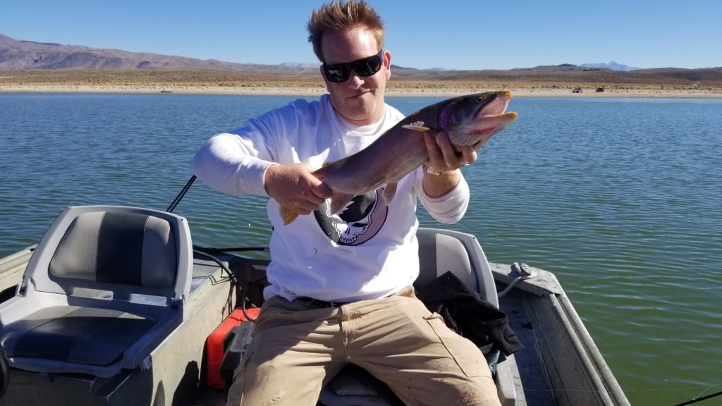 Man holds up large trout on Crowley Lake