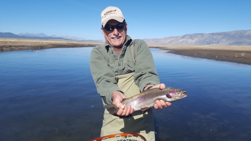Upper Owens River Rainbow near Mammoth Lakes CA held up by a happy Fly Angler