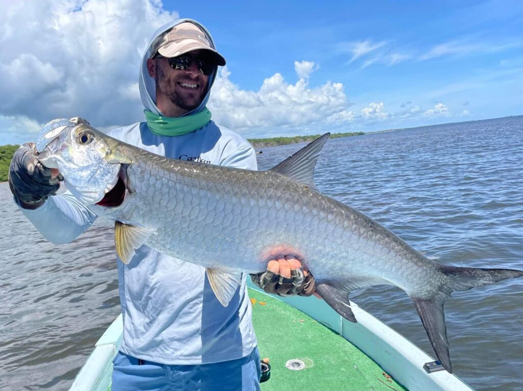 Holding up a Tarpon caught on the fly in Xcalak Mexico