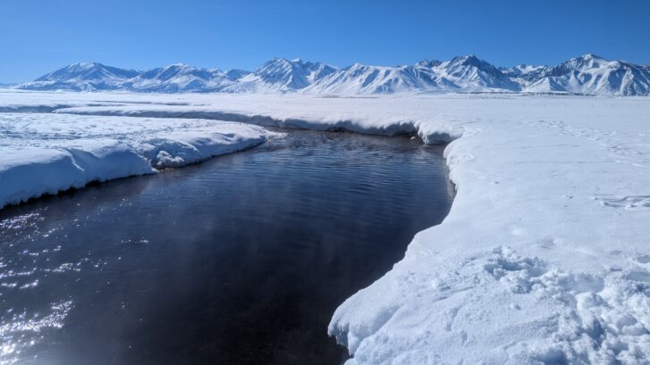 Upper Owens river near Mammoth Lakes California lined with snow